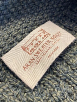 Titelseite 9 Merino Cross Over Neck Aran Coatigan